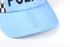 Close up shot of a light blue folding police cap's visor, on a white background.