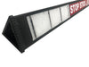 Black stop stick opened, showing the inside- which looks like white foam padding, on a white background