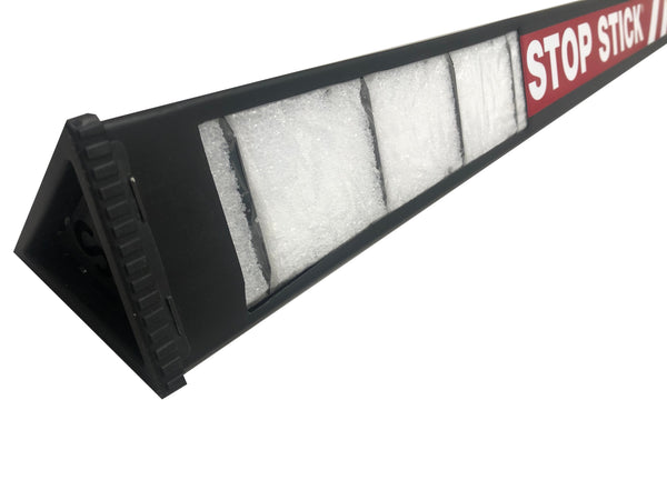 Black stop stick opened, showing the inside- which looks like white foam padding, on a white background